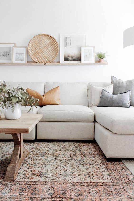 Love this beautiful living room design with a sectional, vintage rug, wood coffee table, and neutral furniture and decor - living room ideas - living room decor - living room furniture - organic modern decor - living room table - meg leonard design