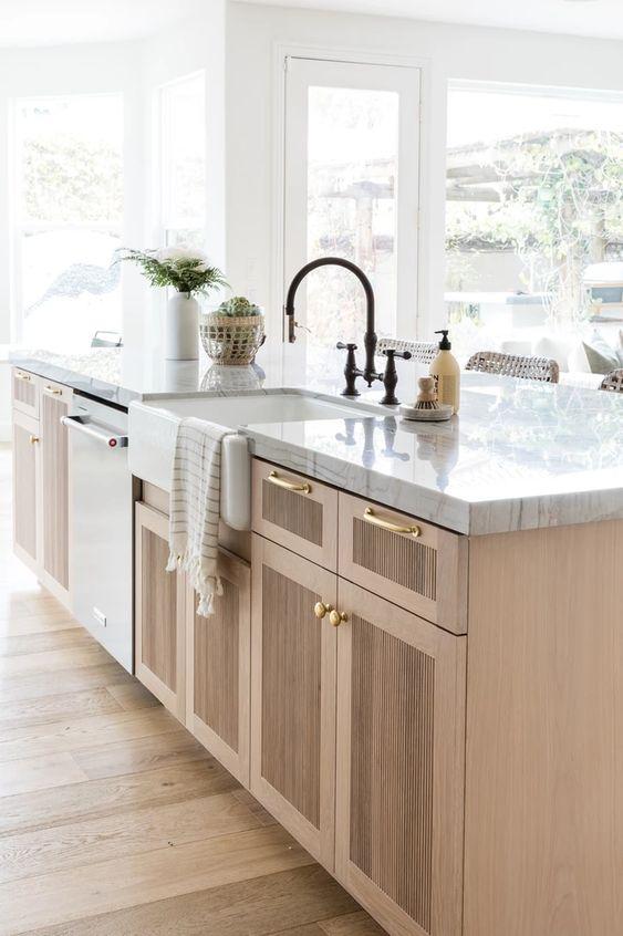 Love this gorgeous warm wood kitchen island with detailing on the cabinet doors, brass door and drawer pulls, and a black or bronze faucet - kitchen design - kitchen cabinet ideas - warm wood kitchen - wood and white kitchen - mixed metals - olive and oak interiors