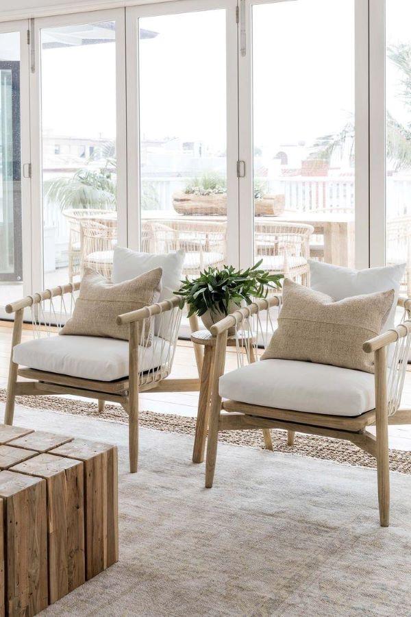 Love this beautiful coastal modern living room design with two arm chairs, a wood coffee table, and neutral furniture and decor - coastal modern design - modern coastal interior design - beach house style - pure salt interiors - katrina scott