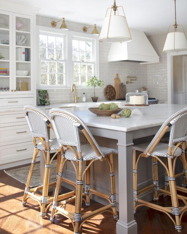 Love this beautiful timeless kitchen design with a gray island, white kitchen cabinets, bistro style counter stools and white and brass pendant lighting - kitchen ideas - kitchen lighting ideas - kitchen island ideas - erin gates