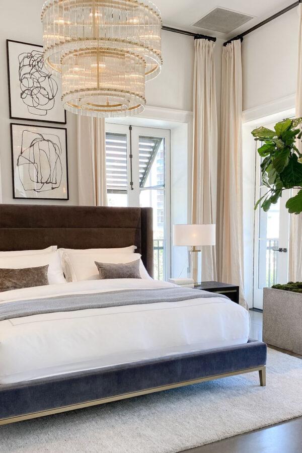 This beautiful master bedroom design features soft layered bedding and neutral decor and furniture - jane at home
