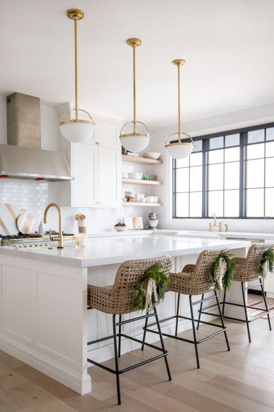 Love this beautiful modern kitchen design with white cabinets, woven counter stools, brass pendant lights, and modern Christmas decor - kitchen ideas - kitchen decor - Christmas decor ideas - modern farmhouse kitchens - christine andrew