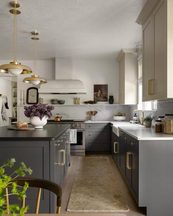 Love this beautiful kitchen design with dark gray lower cabinets and off-white upper cabinets, mixed metal finishes, and a marble backsplash - studio mcgee