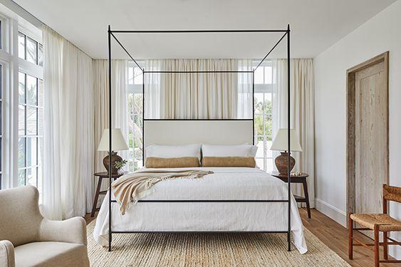 Love this beautiful bedroom design with a black canopy bed and soft neutral curtains, bedding, and decor - quiet luxury - betsy brown - house and home