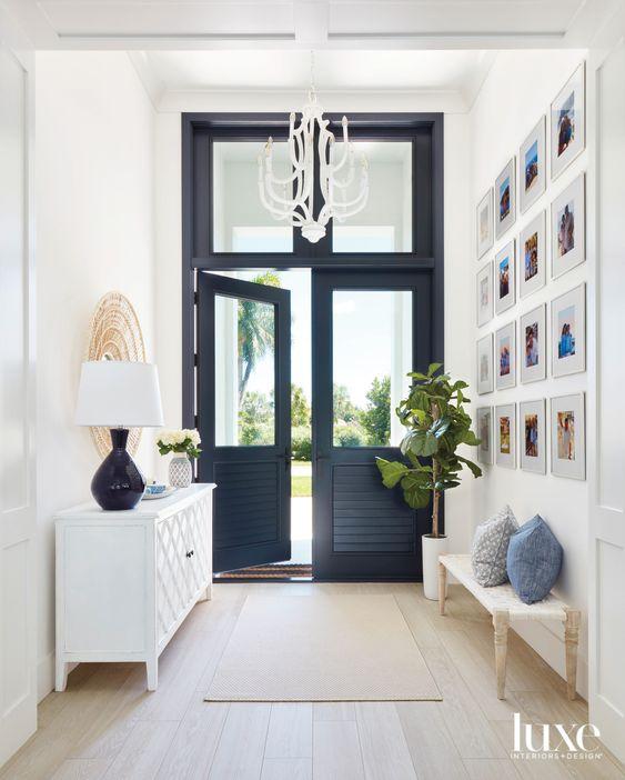 Love this beautiful entryway design featuring double black front doors and high ceilings - luxurious entry - foyer ideas - kara miller interiors