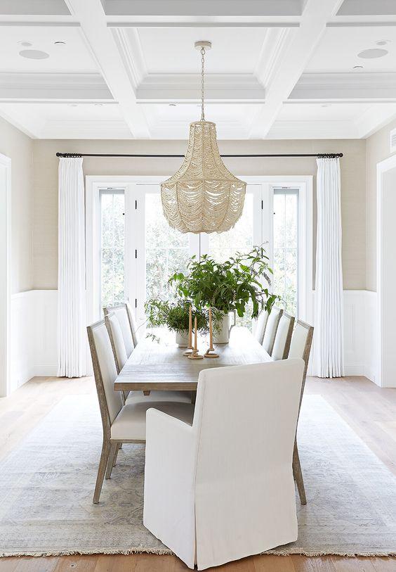 Love this beautiful transitional dining room with a wood dining table, dining chairs and beaded chandelier - dining room decor - transitional interior design - transitional dining room - pure salt interiors