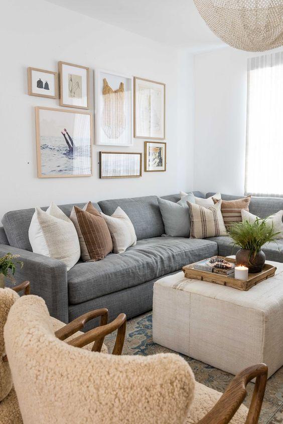Love this beautiful living room design with an ottoman, large gray sectional, and light neutral decor and furniture - living room ideas - living room decor - living room inspo - living room table - modern coastal interior design - coastal cowgirl - pure salt interiors