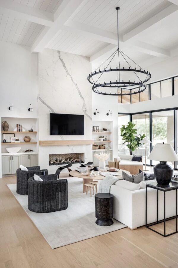Love this beautiful modern living room design with a fireplace, tv wall, and neutral furniture and decor - living room ideas - living room decor - living room furniture - living room lighting - tv wall ideas - living room vaulted ceiling - organic modern decor - the life styled co