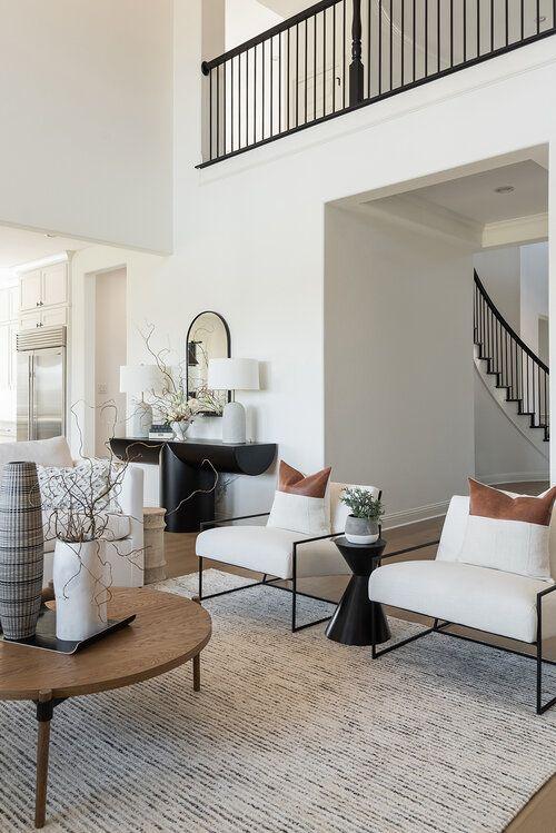 Love this beautiful modern living room design with two modern chairs and neutral decor and furniture - urbanology designs
