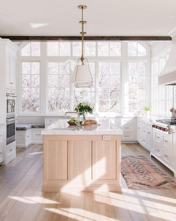 Love this beautiful kitchen design with a light oak wood island, white kitchen cabinets, and white and brass pendant lights - kitchen cabinet ideas - kitchen lighting - kitchen remodel - modern kitchen - timeless kitchen - European farmhouse kitchen - ali henrie