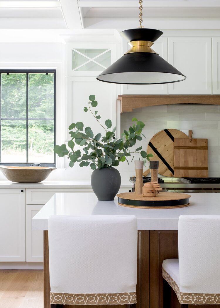 Love this beautiful kitchen design with black and brass pendant lights, white kitchen cabinets, and a wood kitchen island - kitchen remodel - white kitchens - kitchen cabinet ideas - kitchen island ideas - kitchen lighting ideas 