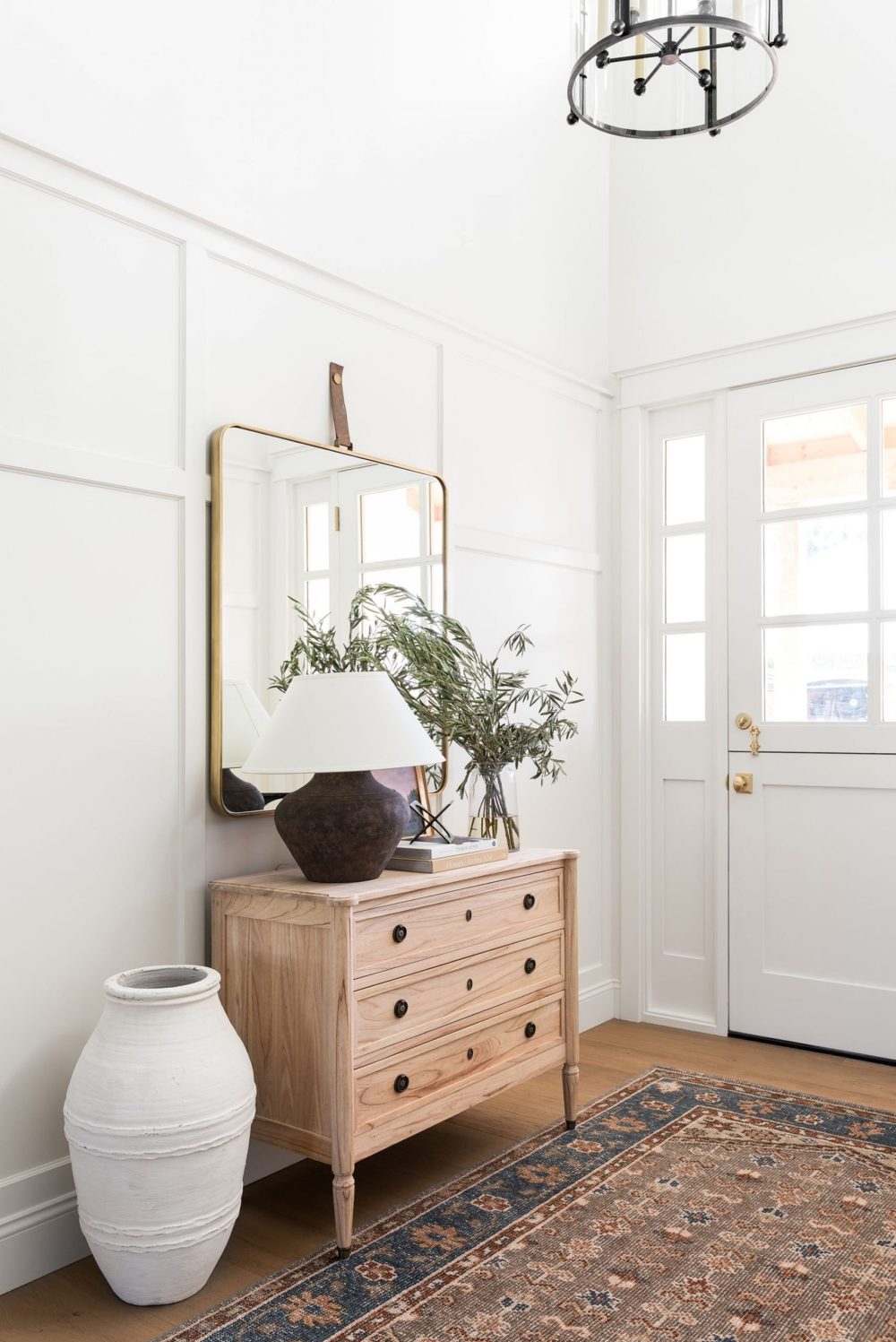 Love this beautiful modern entryway with a wood cabinet, brass mirror, rug, baskets and neutral decor - entryway ideas - foyer - entryway furniture - entryway decor