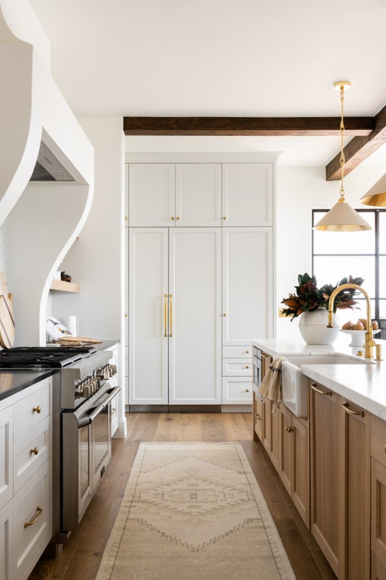 Love this beautiful European style kitchen design with a light oak wood island, white cabinets, and brass pendant lights - kitchen ideas - kitchen decor - kitchen island ideas - kitchen lighting - kitchen cabinet ideas