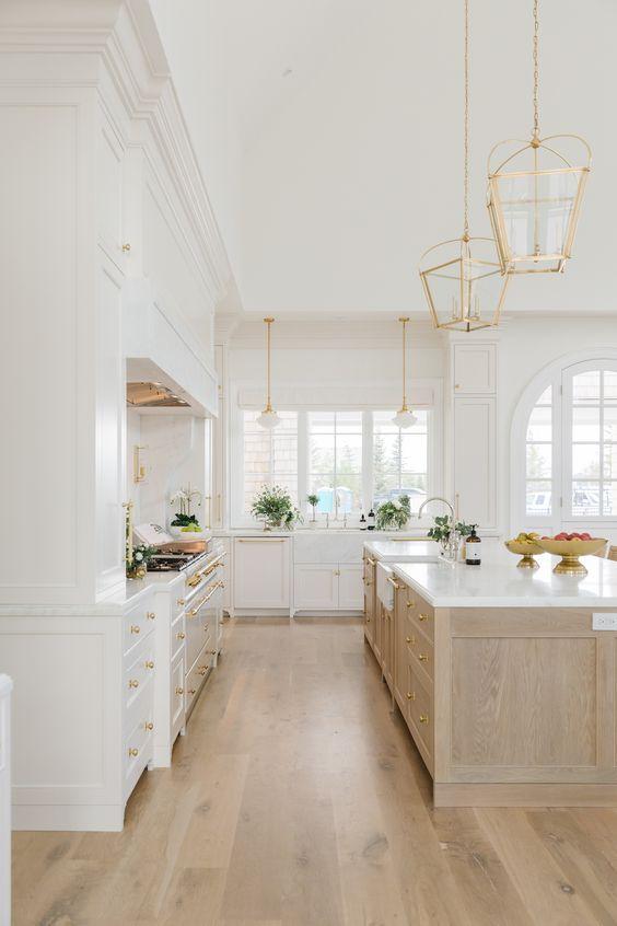 Love this beautiful kitchen design with a mix of white and white oak kitchen cabinets, brass metal finishes, and a large kitchen island - designer kitchen - dream kitchen design - kitchen interior design decor - kitchen inspiration - cambridge home co - the cabinet gallery utah