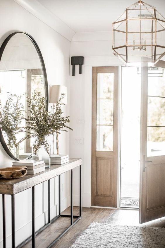 Love this beautiful modern entryway with a console table and large round mirror - public 311 design