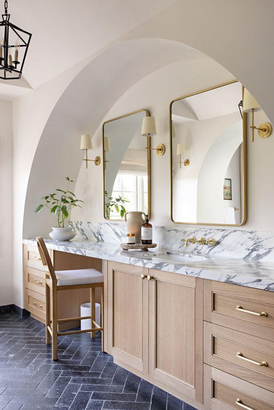 Love this elegant modern organic bathroom design with light wood vanity cabinets and brass hardware and mirrors - intimate living interiors