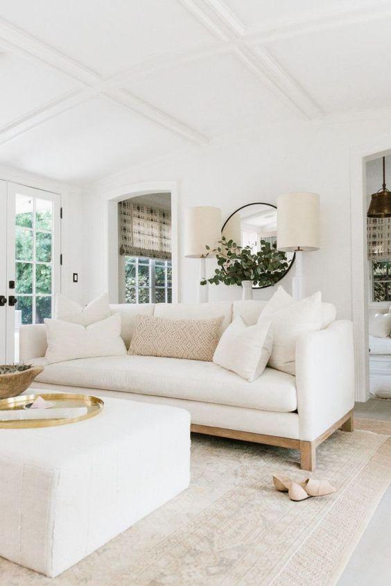 Love this elegant living room design with a white sofa and ottoman and light neutral decor and furniture - erin fetherston - transitional decor - living room decor