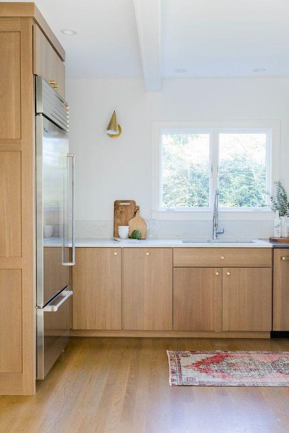 https://jane-athome.com/wp-content/uploads/2023/10/Beautiful-modern-kitchen-with-light-wood-cabinets-white-walls-and-vintage-rug-kitchen-ideas-kitchen-remodel-kitchen-design-rehabitat-interior-design.jpeg
