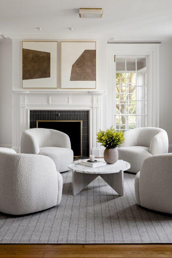 Beautiful modern living room seating area with curved swivel chairs - quiet luxury - elizabeth lawson design