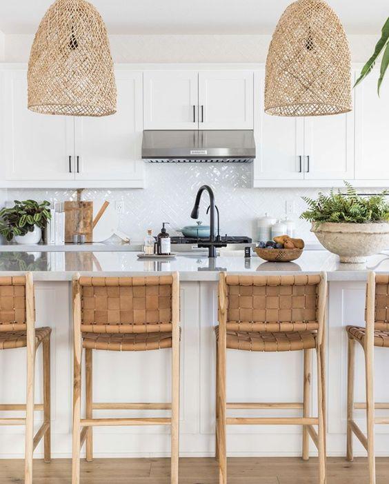 Love this beautiful modern coastal kitchen design, featuring woven pendant lighting, white kitchen cabinets, and leather counter stools - pure salt interiors