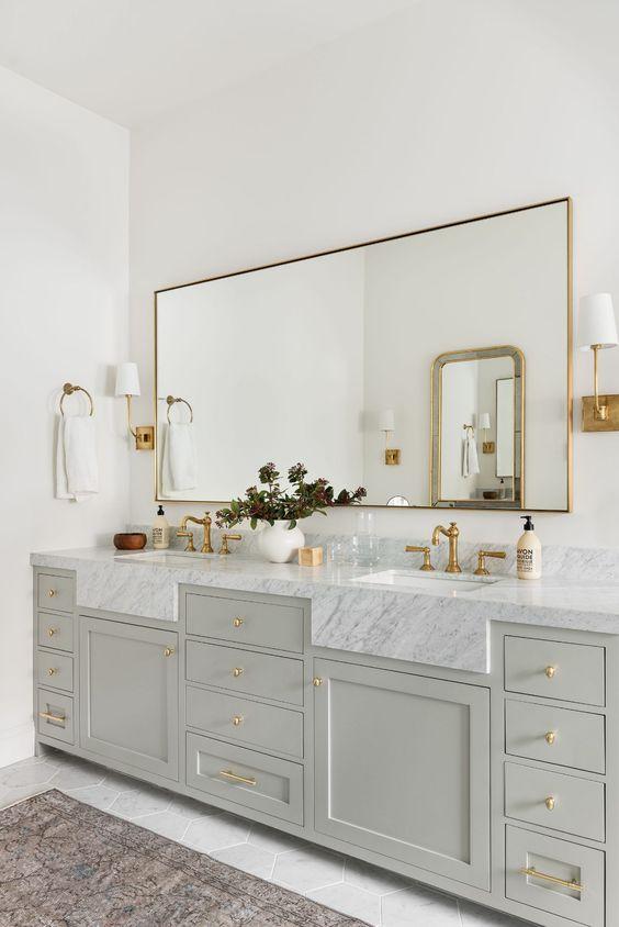 Love this beautiful bathroom design with a long bathroom mirror and brass metal finishes - studio mcgee