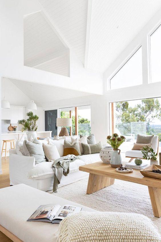 Love this beautiful living room and great room with vaulted ceilings, white furniture, wood coffee table, and neutral decor - home beautiful