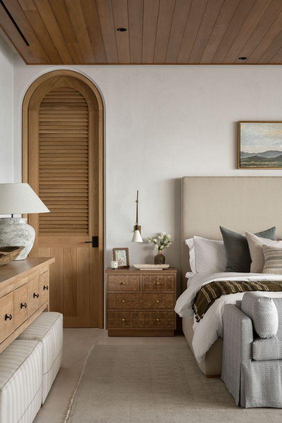 This beautiful master bedroom design features soft layered bedding and neutral decor and furniture - studio mcgee