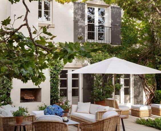Love this beautiful outdoor living area and patio belonging to nancy meyers, complete with an outdoor fireplace and gorgeous landscaping - arch digest