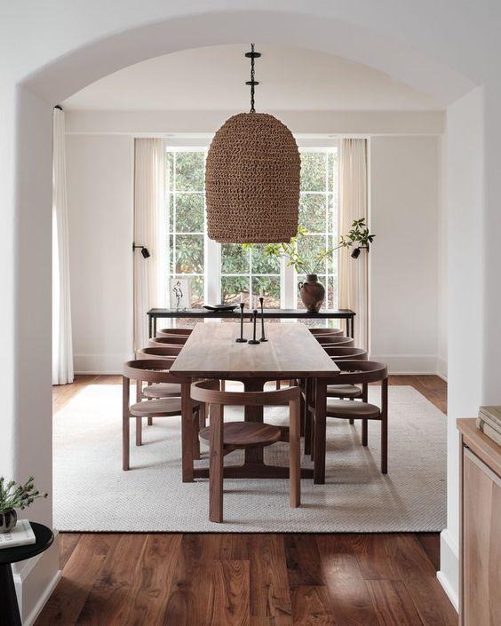 Love this beautiful modern organic dining room design with a wood dining table, curved dining chairs, and woven light fixtures - clare kennedy interiors
