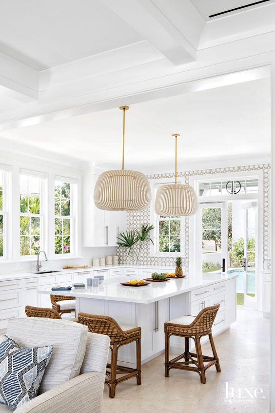 Love this beautiful coastal kitchen design with white cabinets and woven pendant lights - coastal kitchen ideas - coastal kitchen decor - modern coastal decor - coastal boho interiors - modern coastal interior design - leah muller interiors - luxesource