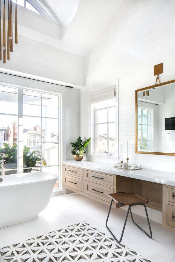 Love this beautiful modern transitional bathroom design with light wood vanity cabinets, freestanding tub, and gorgeous chandelier - lindye galloway design