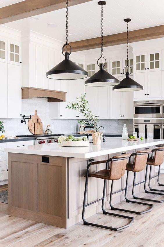 Love this beautiful modern kitchen design with a light wood kitchen island, white cabinets, black pendant lighting, and warm wood elements - remedy design
