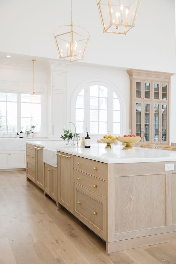 Love this beautiful kitchen island design with a light oak wood kitchen island and brass metal finishes - the cabinet gallery utah - cambridge home co.