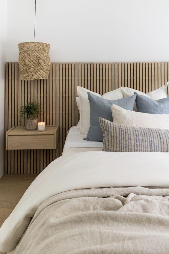 This beautiful master bedroom design features soft layered bedding and neutral decor and furniture - pure salt interiors