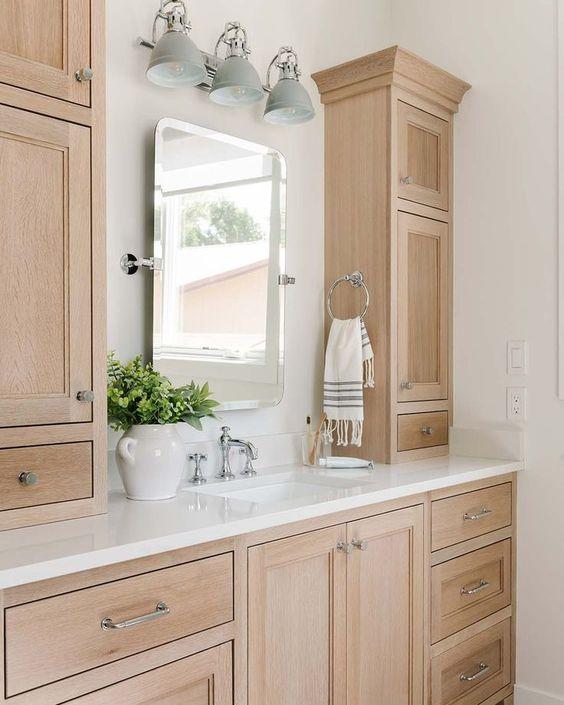 Love this beautiful bathroom design with white oak wood cabinets, mixed metal finishes, and a warm aesthetic - remedy design firm