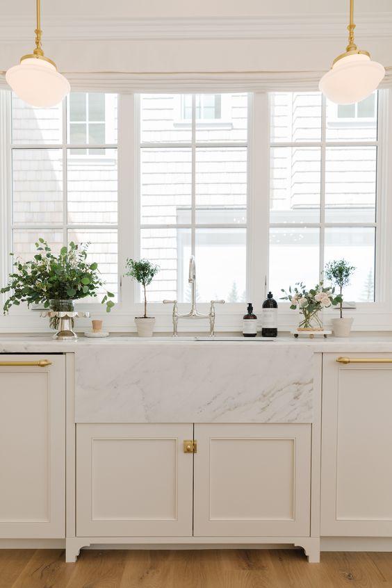 Love the styling in this beautiful kitchen design with white cabinets and brass lighting and cabinet pulls - the cabinet gallery utah - cambridge home co