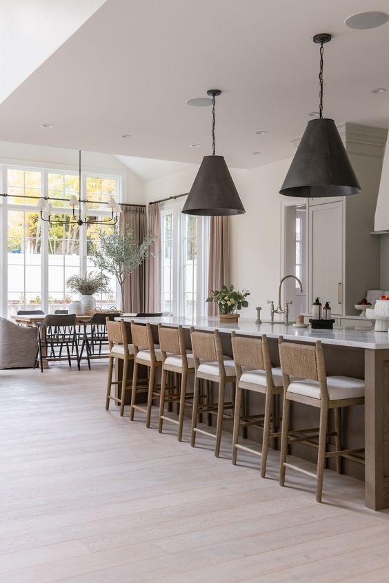Love this beautiful California casual style kitchen design with a wood kitchen island, woven counter stools, black pendant lighting, a warm, aesthetic, neutral decor, and chic west coast style - the cabinet gallery utah - cambridge home co
