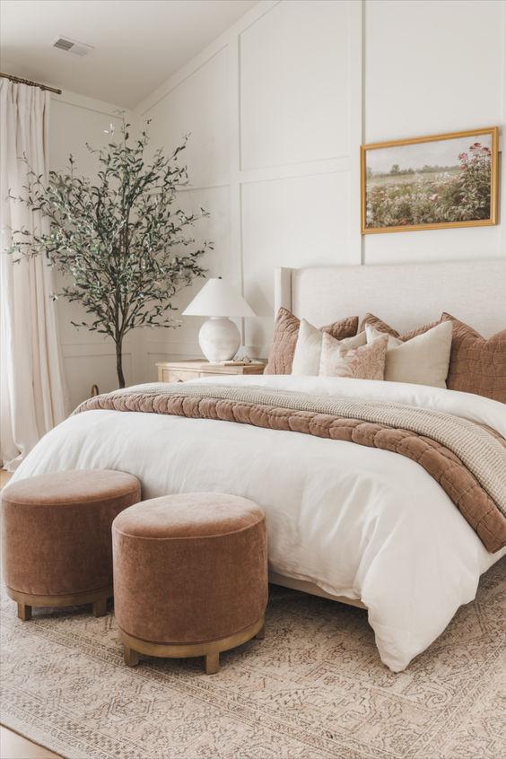 This beautiful master bedroom design features soft layered bedding and neutral decor and furniture - alexis andra austin