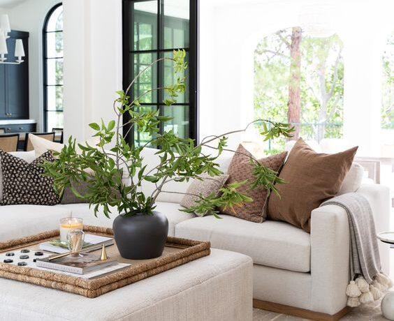 Love this beautiful modern coastal style living room design with neutral furniture and decor and a warm aesthetic - house of four design