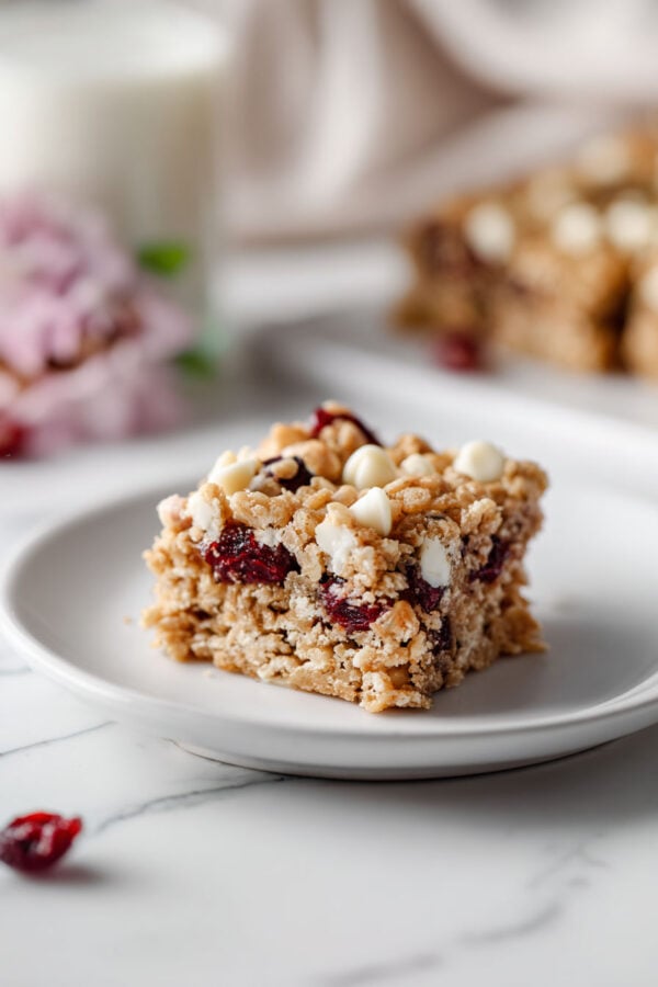 These rich and buttery oatmeal blondies are made in one bowl and packed with white chocolate chips and dried cranberries for a quick and easy dessert, snack, or breakfast everyone loves - jane at home