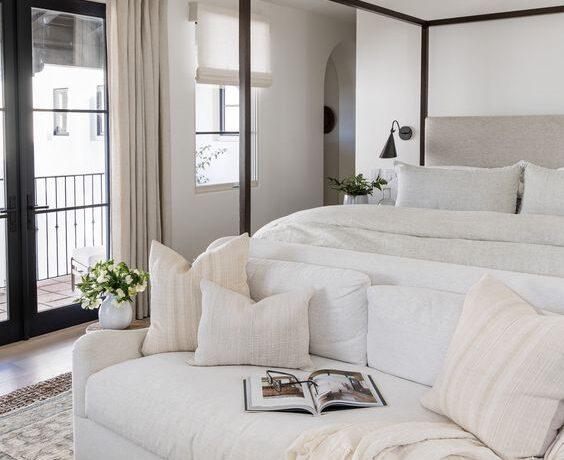 Love this beautiful cozy bedroom design with a neutral color palette, canopy bed, and settee at the end of the bed - pure salt interiors