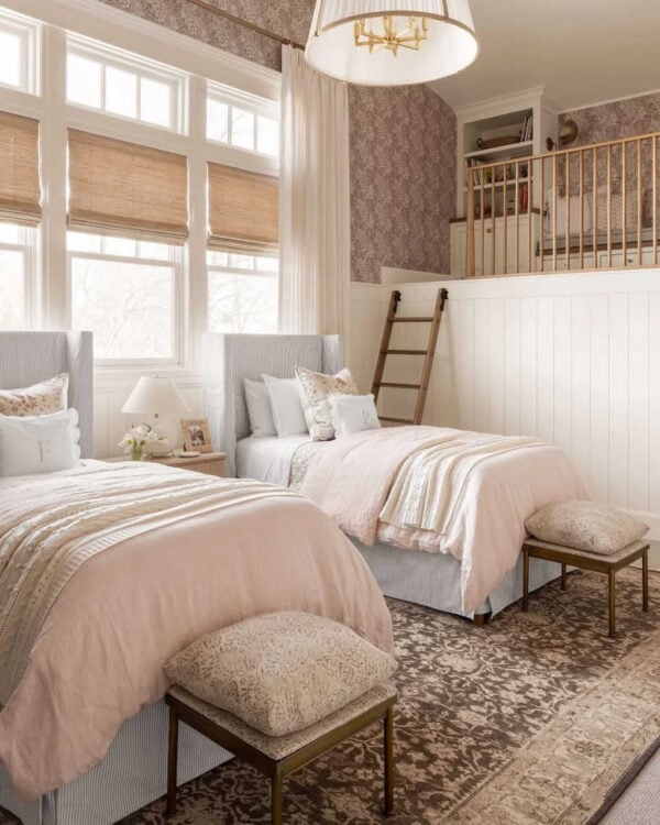 Serene bedroom mixing soft neutral patterns in bedding, pillows, and rug.