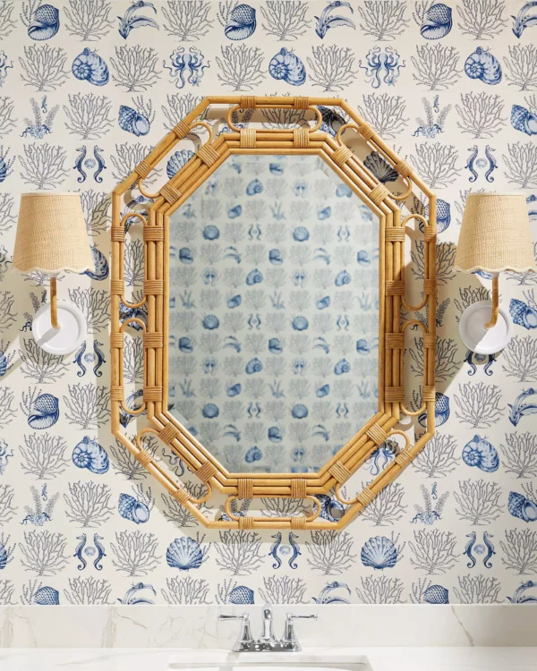 Powder room with nautical wallpaper, marble vanity, brass sconces, and statement mirror — small bathroom decorating ideas and inspiration.