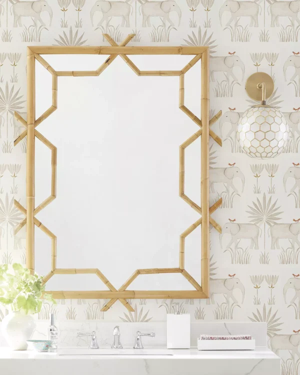 Powder room with bold wallpaper, marble vanity, brass sconces, and statement mirror — small bathroom decorating ideas and inspiration.