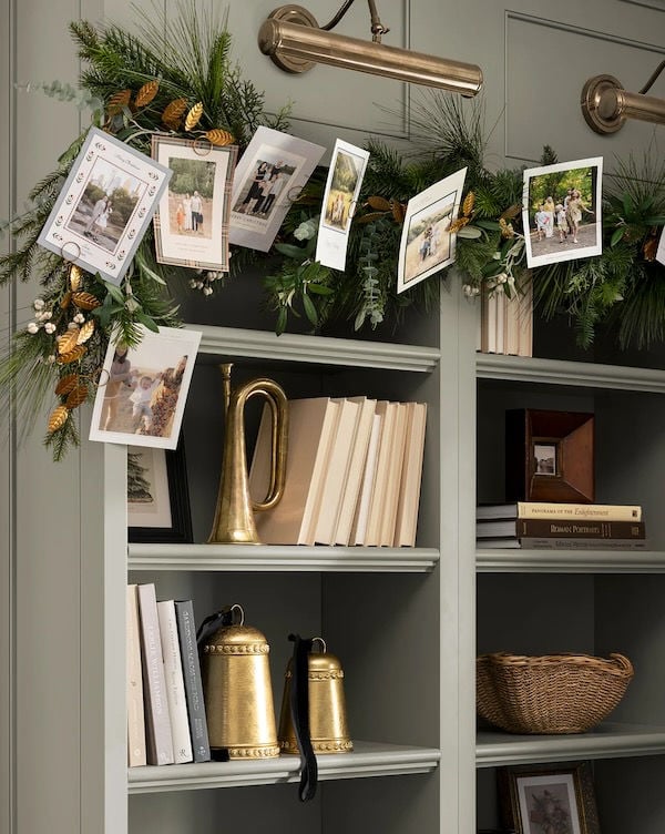 Love this beautiful neutral Christmas decor idea, featuring a card holder garland draped on a styled bookshelf - studio mcgee