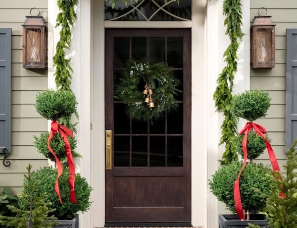 Beautiful Christmas front porch with garlands and topiaries - studio mcgee