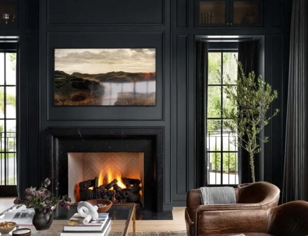 Warm, layered living room featuring soft green, faded blue, warm neutral, and natural wood tones inspired by 2027 interior color trends.