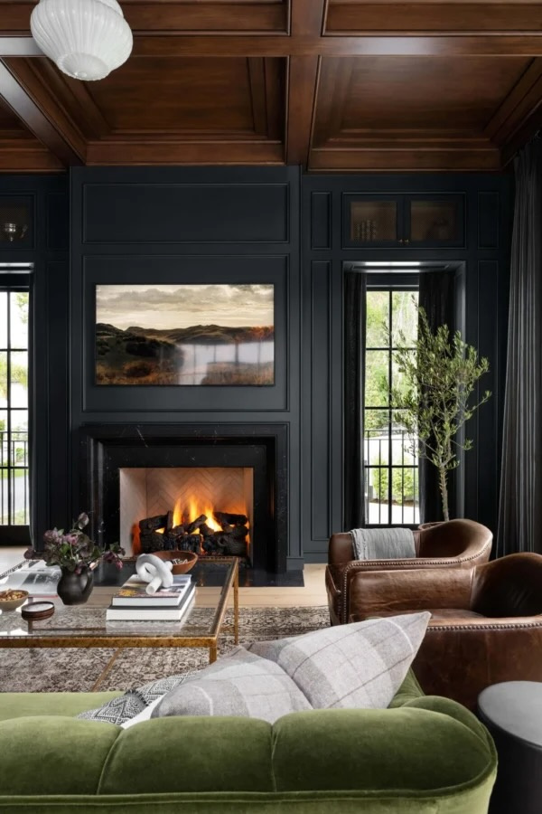 Warm, layered living room featuring soft green, faded blue, warm neutral, and natural wood tones inspired by 2027 interior color trends.