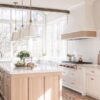 Love this beautiful kitchen design with a light oak wood island, white kitchen cabinets, and white and brass pendant lights - kitchen cabinet ideas - kitchen lighting - kitchen remodel - modern kitchen - timeless kitchen - European farmhouse kitchen - ali henrie - hebdon studios - rebekah westover