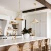 Love this beautiful organic modern kitchen design with curved barstools and pendant lighting over the island